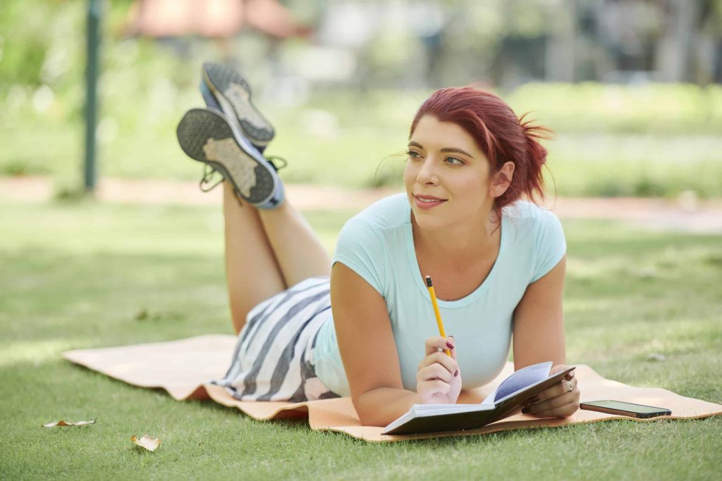 Young woman bullet journaling